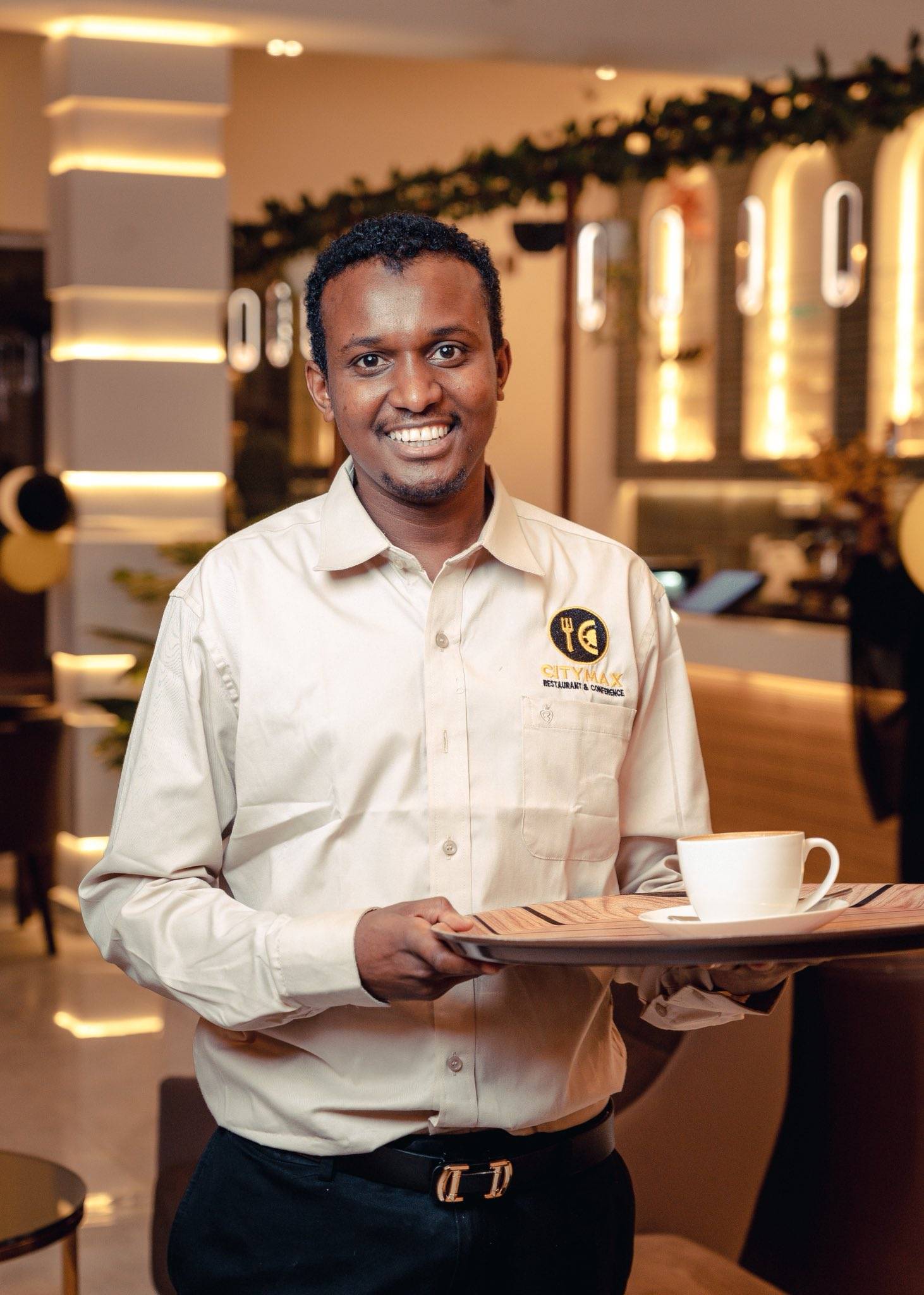 A restaurant team member in branded uniform on the floor
